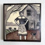Photo of a piece of art showing a person wearing a dress and standing in front of a barn, next to a tree, with open farmland behind them and hills in the distance. A chicken is walking next to them.
