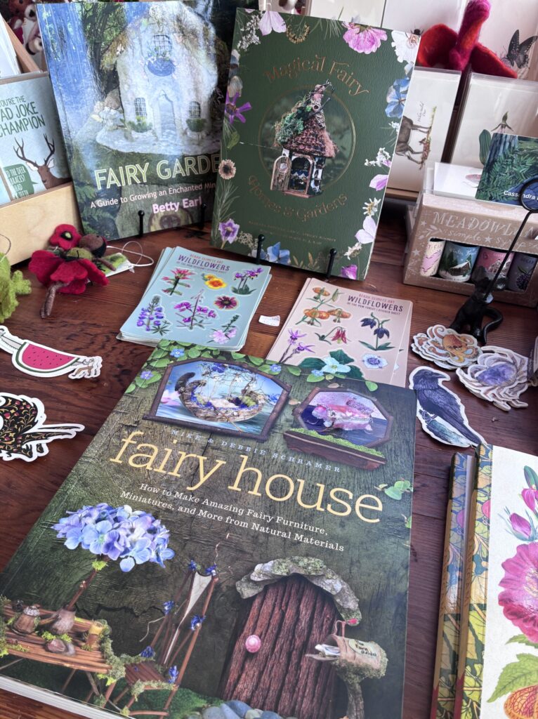 Display of books and gifts at Summer Beam Books, with a book about creating fairy houses in the foreground.