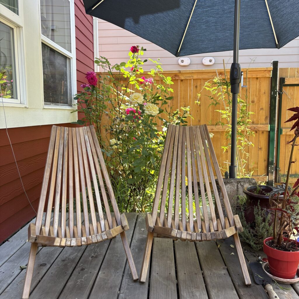 Two wooden chairs on the back deck of The Farmhouse.