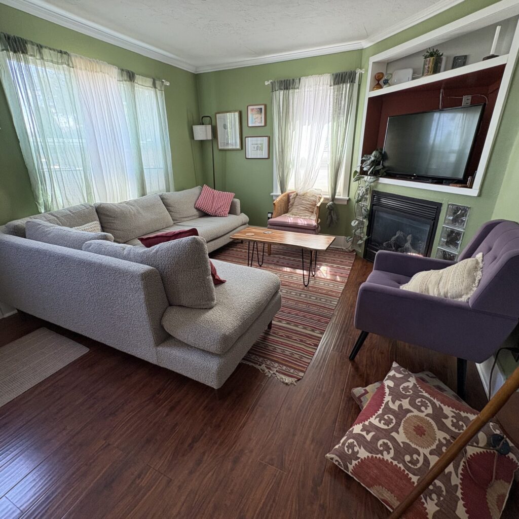 Another gathering spot at The Farmhouse, with wraparound couch and chairs.
